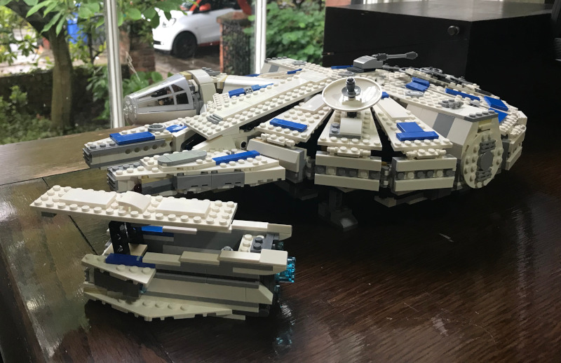 LEGO Millenium Falcon with a more traditional silhouette. In front of it is a kind of LEGO skiff/landspeeder type thing.