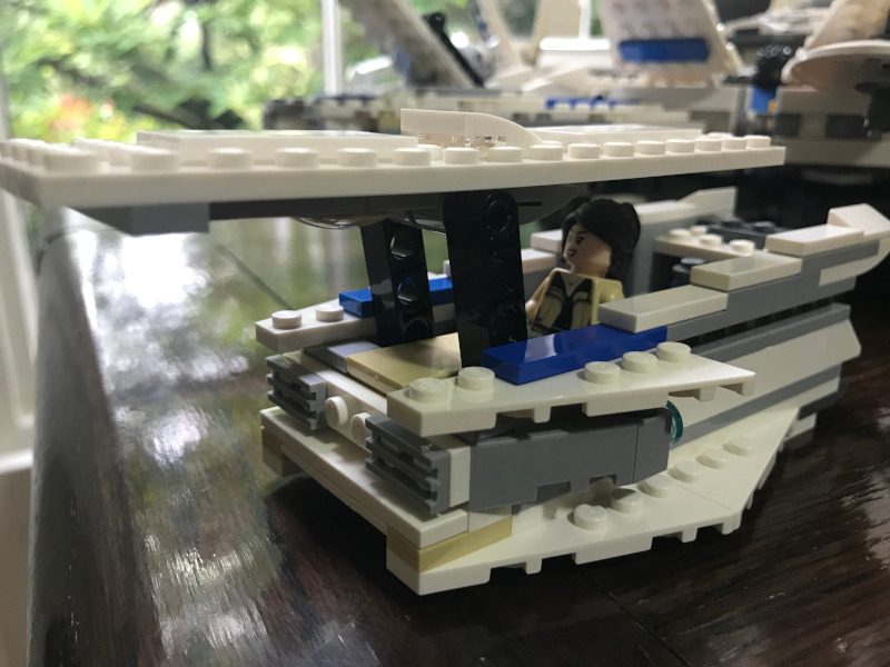 A close up of the land speeder/skiff thing. The LEGO woman is sitting in it at the controls (though you can't actually see the controls in this picture).