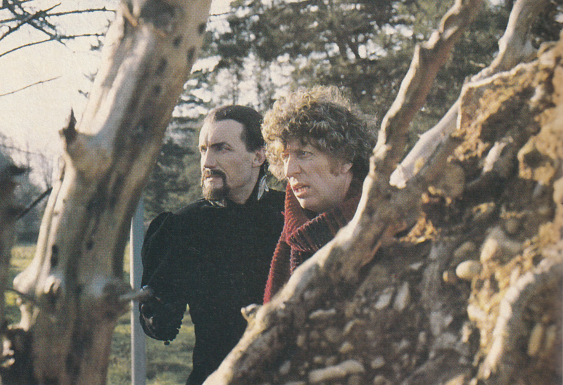 Picture of the Fourth Doctor and the Master peering through trees