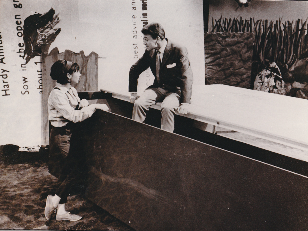Black and White photo from Planet of Giants.  Ian is sitting on an open matchbox and Susan is leaning against it.