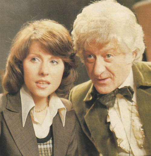 The third Doctor and Sarah.  Sarah in a brown jacket with a wonderful 1970s collar.
