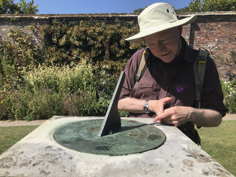Himself working out the time on a sundial