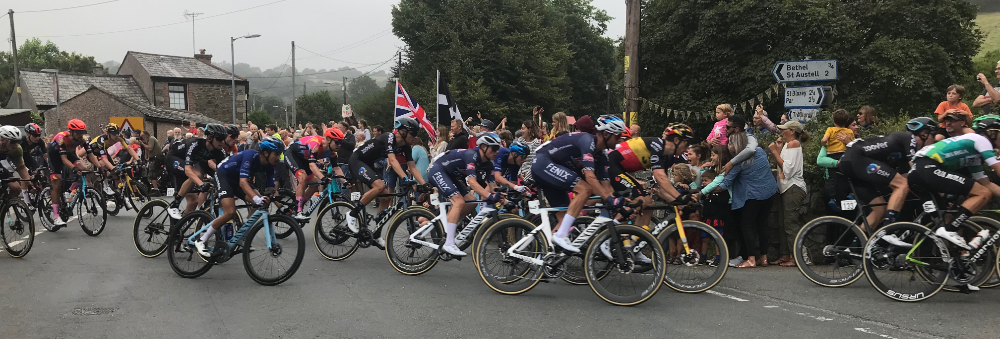 Lots of cyclists going fast on a road