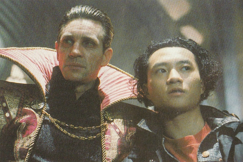 Eric Roberts as the Master in a vaguely Time Lord collar style cape and Yee Jee Tso as Change Lee.