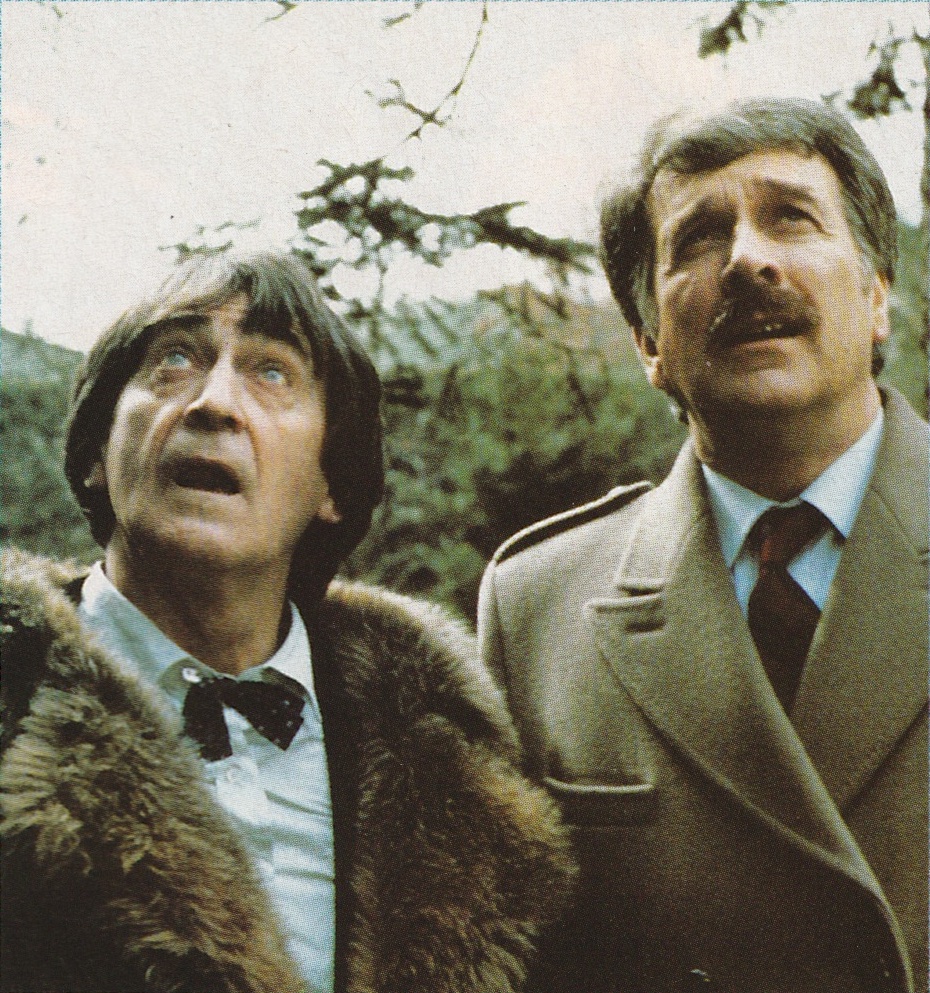 The Second Doctor and the Brigader, from the Five Doctors, looking up.