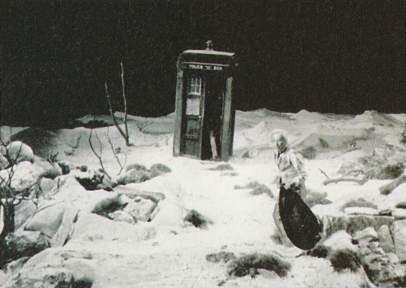 Shot from An Unearthly Child.  The First Doctor runs towards the Tardis across a deserted landscape.