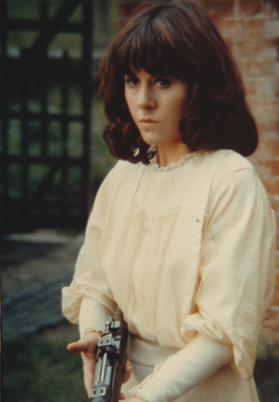Sarah from Pyramids of Mars, holding a gun