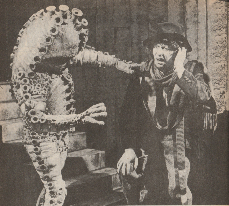 Black and White photo of the Fourth Doctor being menaced by a Zygon.