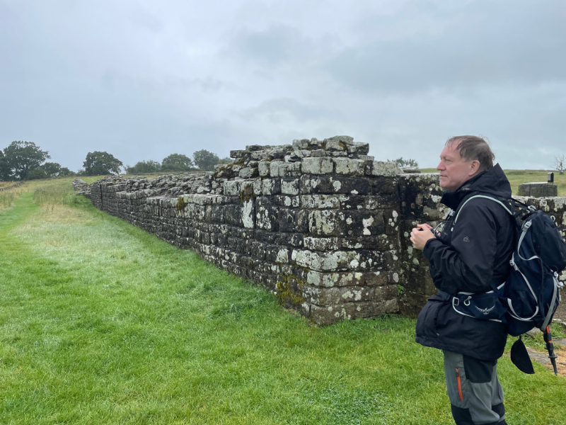 B stand next to what looks like a bit of Hadrian's Wall but is, in fact, the wall of a fort.