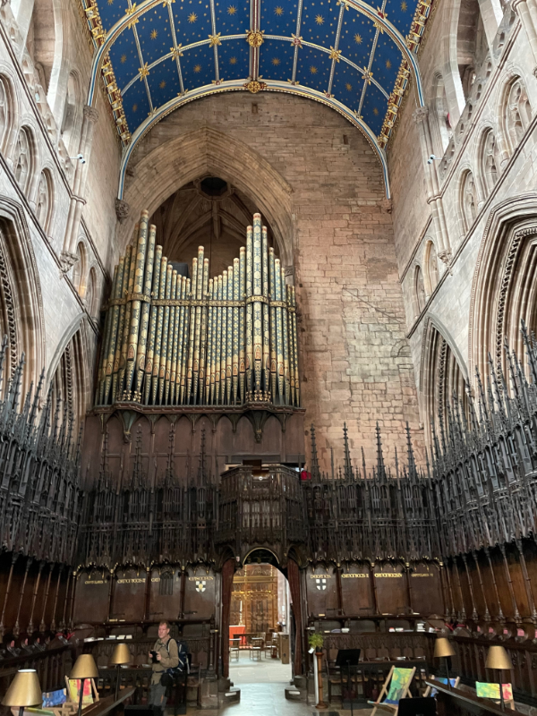Far wall of the cathedral.  An organ reaches from one side just past the middle.