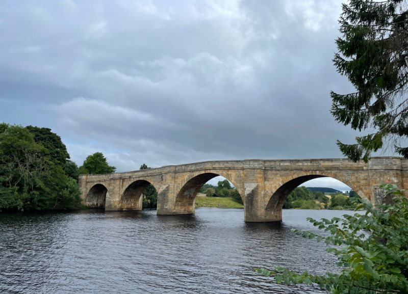 Arched bridge over a river.