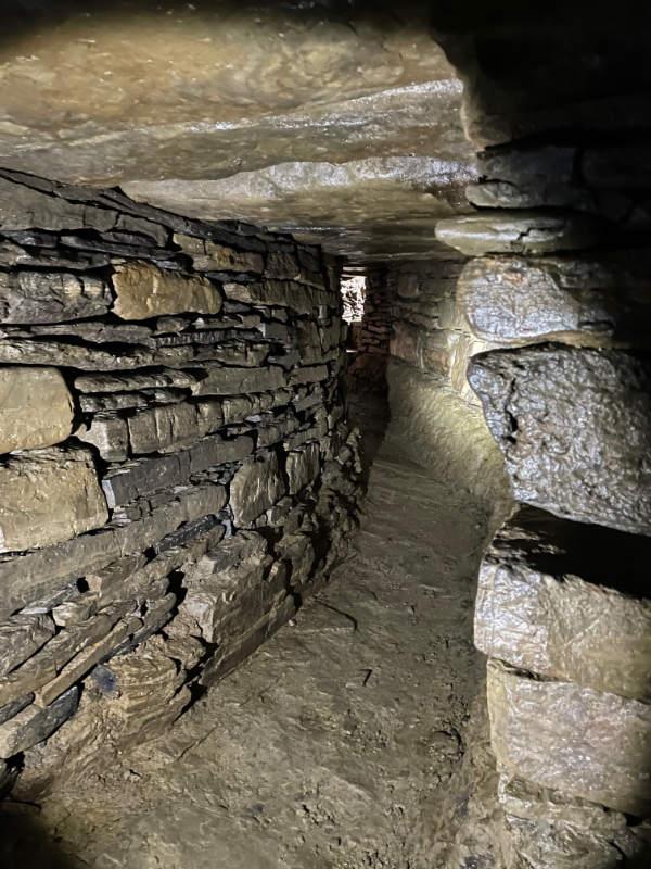 A curving stone lined tunnel.