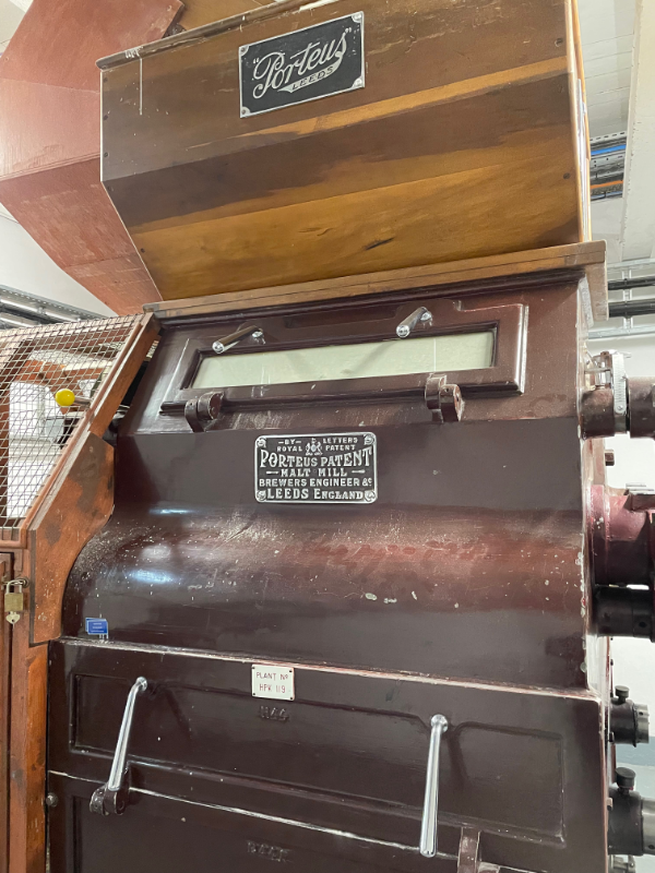 A different view of the same machine.  A small plaque reads Porteus Patent Malt Mill Brewers Engineer Leeds England.