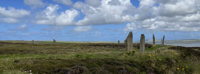 Standing stones the left with a ditch curving round.