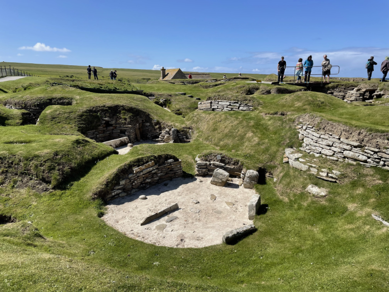 Grass covered sand dunes, revealing a circular room.