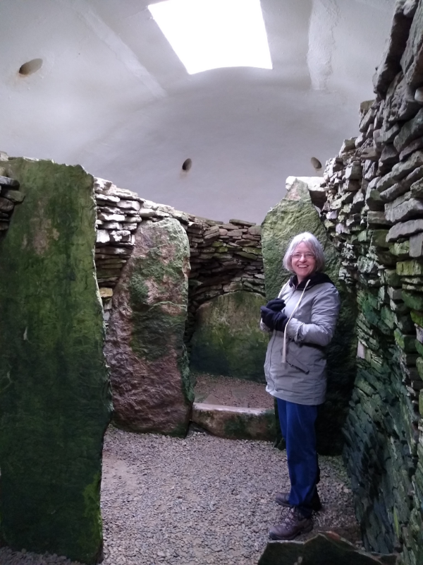 Me inside the tomb. False white roof with skylight. Upright stones dived the walls.