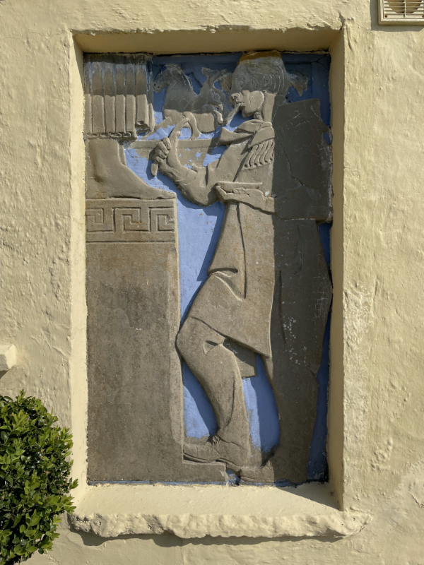 Frieze of man - maybe painting a statues feet.