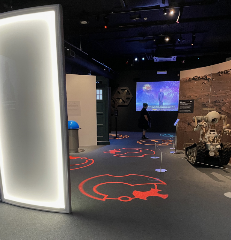 Gallifreyan letters projected on the floor.