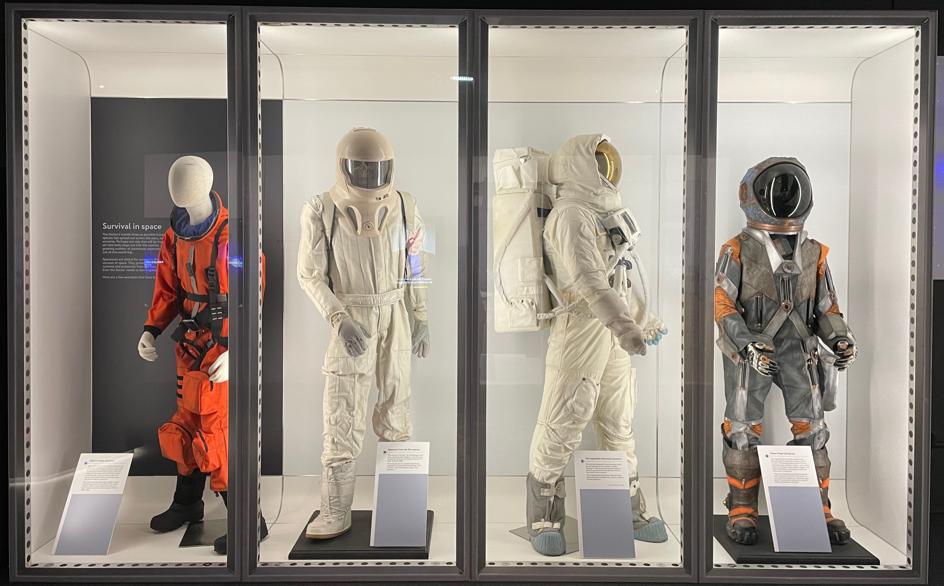 Display of four spacesuits.