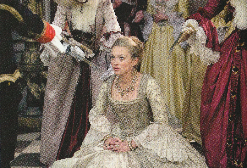 Madame de Pompadour kneeling.  The hands of the clockwork robots are just visible.