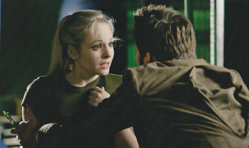 Picture of Ten and Jenny from The Doctor's Daughter.  Ten has his back to the camera and is holding Jenny (and the sonic screwdriver).