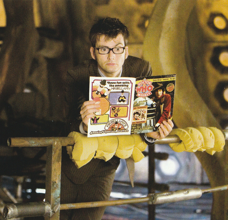 David Tennant leaning on one of the railings in the Tardis set reading the first issue of Doctor Who Magazine.