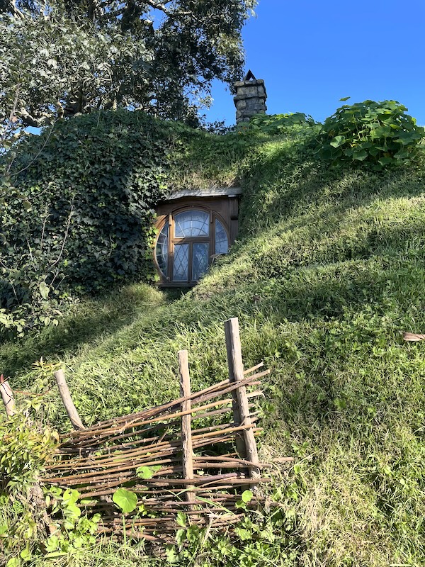 A window in a hillside. Chimney above.