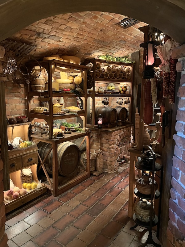 A well-stocked larder with food and barrels.