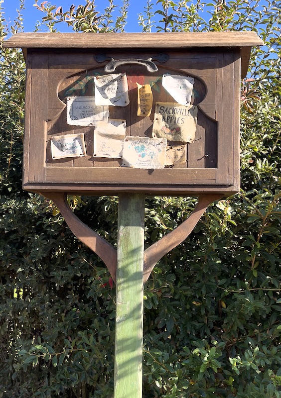 A noticeboard - one notice advertises Sackville Apples.