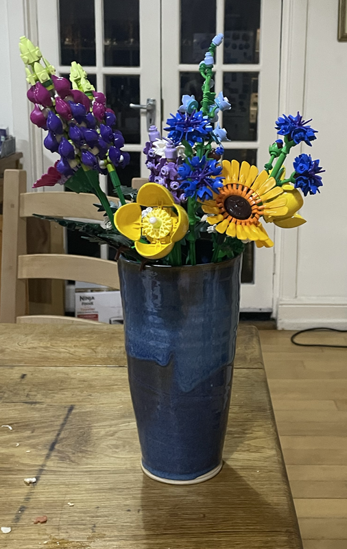 Flowers made from LEGO in a blue vase.