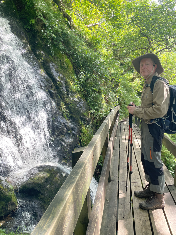 B. On a wooden bridge by a watefall.