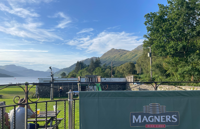 Blue sky, mountains on the right. Loch on the left.