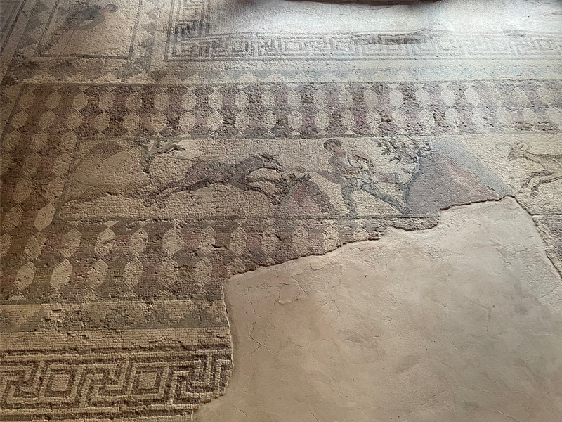 Mosaic of a man with a spear who seems to be attacking a horse
