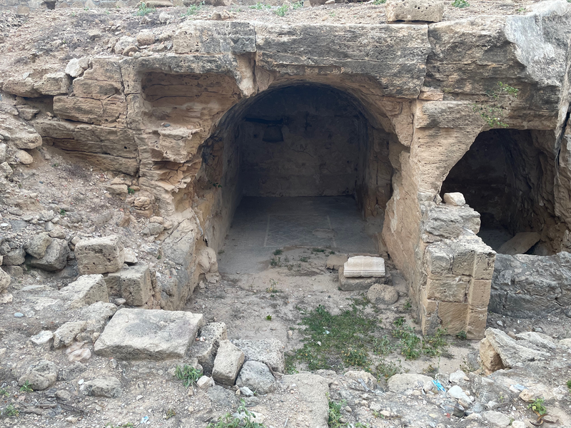 A cellar, now open at the front with a mosaic floor visible inside.