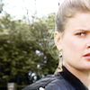 Ace.  Half her face.  Dangly earing.  Greenery in background