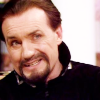 Ainley Master, head to one side looking amused.