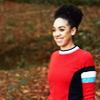 Bill from Doctor Who.  Side view, waist up in red jumper from Eaters of Light.