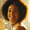 Bill from Doctor Who.  Head and shoulders, turned towards the camera with light behind her.