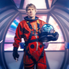 Dan in an orange space suit.