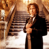 The Eighth Doctor standing before some stairs.  There is smoke.