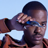The Fifteenth Doctor holding his sonic screwdriver at eye level.