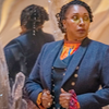 The Fugitive Doctor holding her lapels.