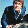 Harry Sullivan looking over a rock as if he's climbing it.