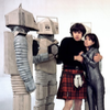 Jamie and Zoe holding each other and threatened by White Robots - colour shot