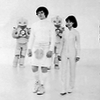 Jamie and Zoe walking in white clothes.  White Robots behind them from the Mind Robber.