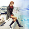 Li` Shaw from Doctor Who seated on a railing.