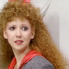 Mel from Doctor Who: Head and shoulders looking over her shoulder towards the camera.