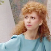 Mel from Doctor Who in a blue top.  Head and shoulders looking away from camera.