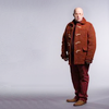 Nardole in orange against a plain background.