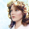 Nyssa with loose curls looking left.